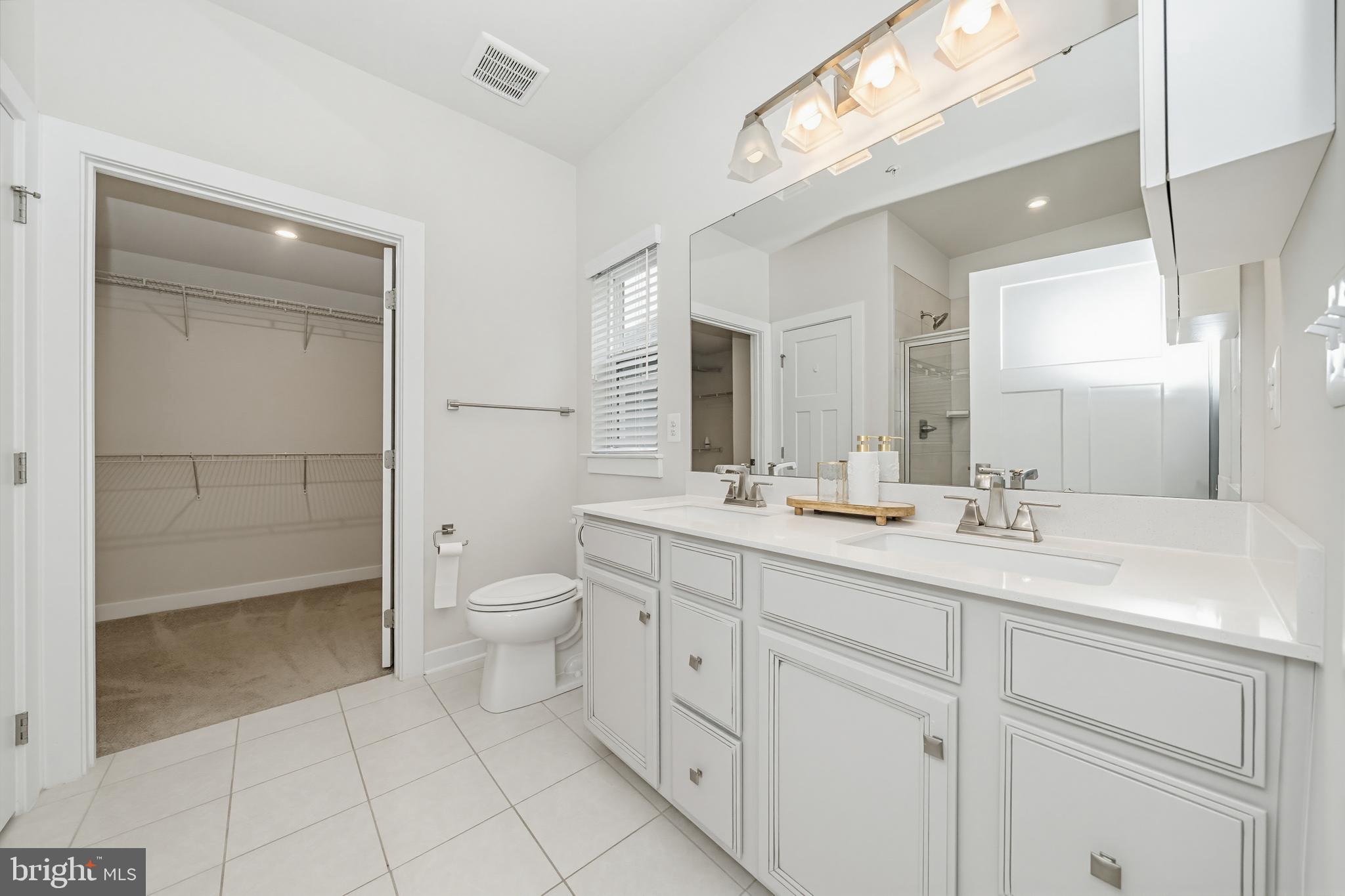 1326 Stonefly Lane Odenton, MD 21113 - Photo 23 of 48 a spacious bathroom with a granite countertop sink a toilet and a shower