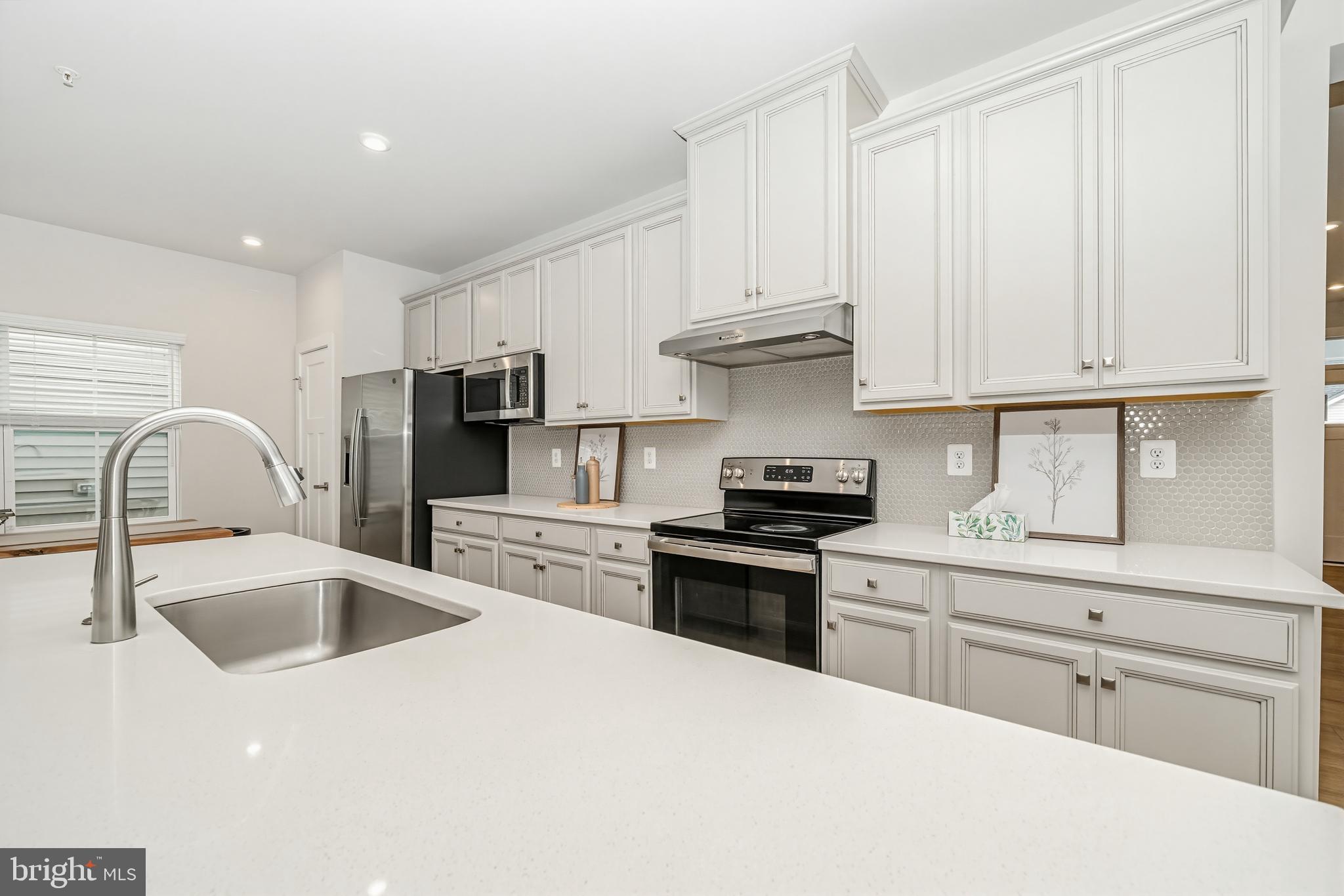 1326 Stonefly Lane Odenton, MD 21113 - Photo 7 of 48 a kitchen with stainless steel appliances granite countertop a sink a stove and refrigerator