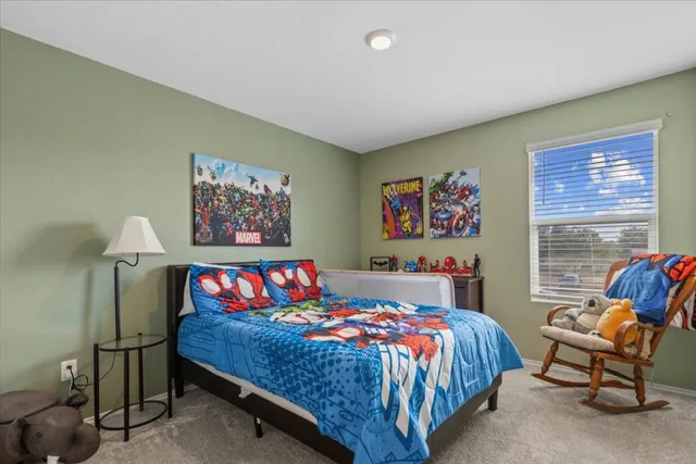 a bedroom with furniture and a window