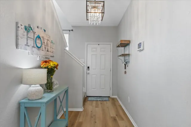 a view of entryway and hall with wooden floor
