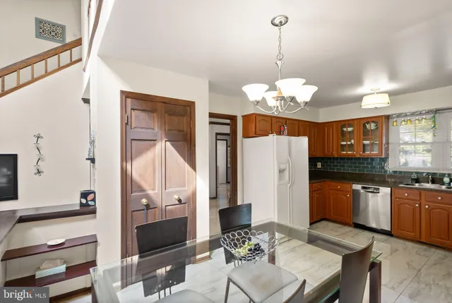 a view of a dining room with furniture a chandelier and wooden floor