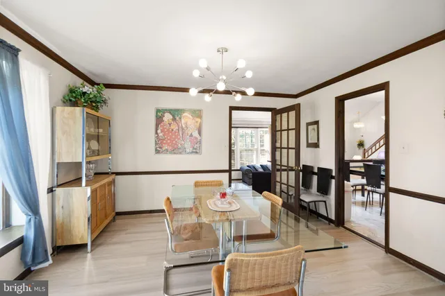 a view of a hallway with wooden floor and living room
