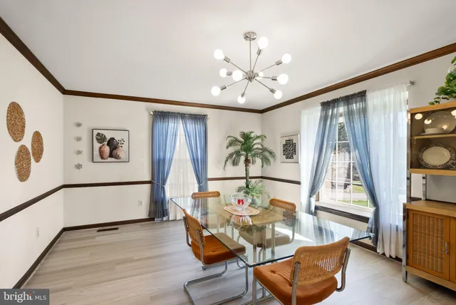 a bedroom with a large bed window and dresser