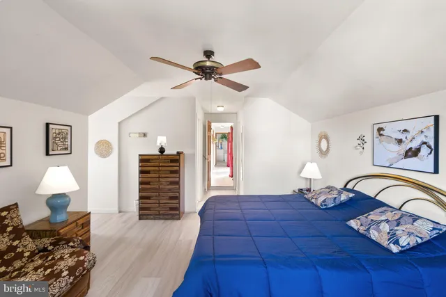 a bedroom with a bed dresser and a window