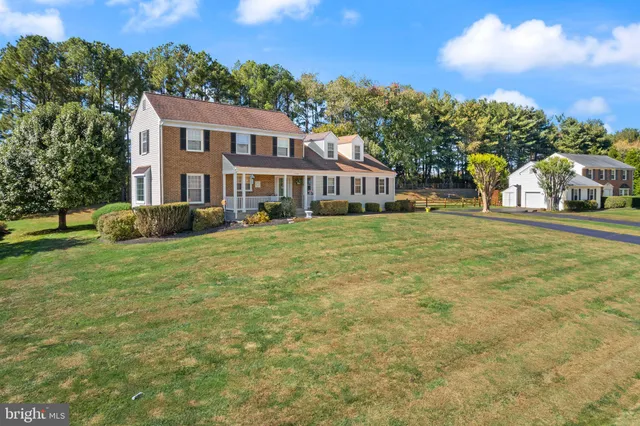 a view of a house with a yard and sitting area
