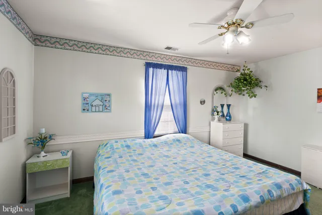 a bedroom with furniture and a potted plant