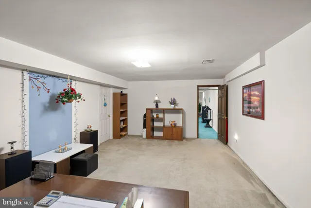 a view of a room with gym equipment and a large window