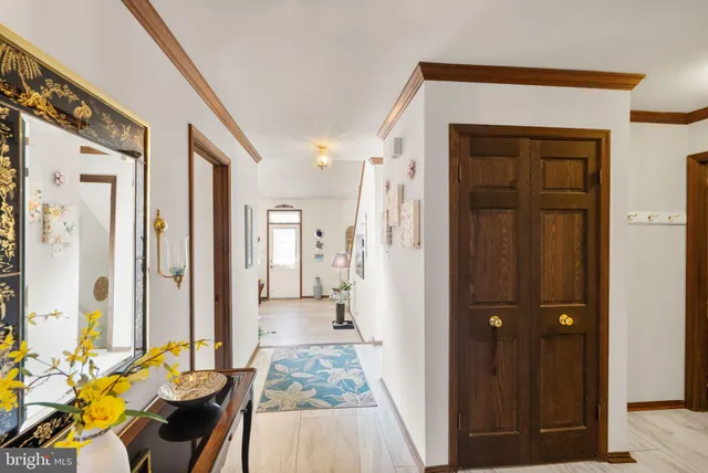 a living room with furniture a fireplace and a large window