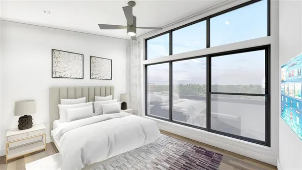 a bedroom with a large bed and a large window