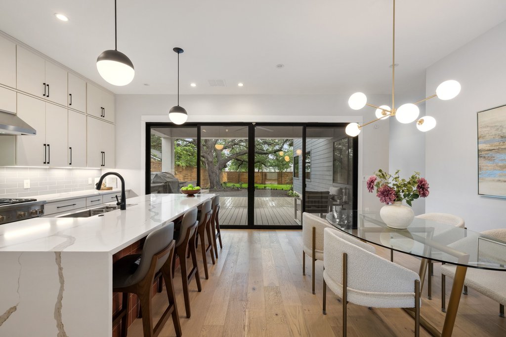5405 Montview Street Austin, TX 78756 - Photo 14 of 40 Hosting is effortless with stackable 4-panel sliding glass doors that create a seamless flow between indoor and outdoor spaces.