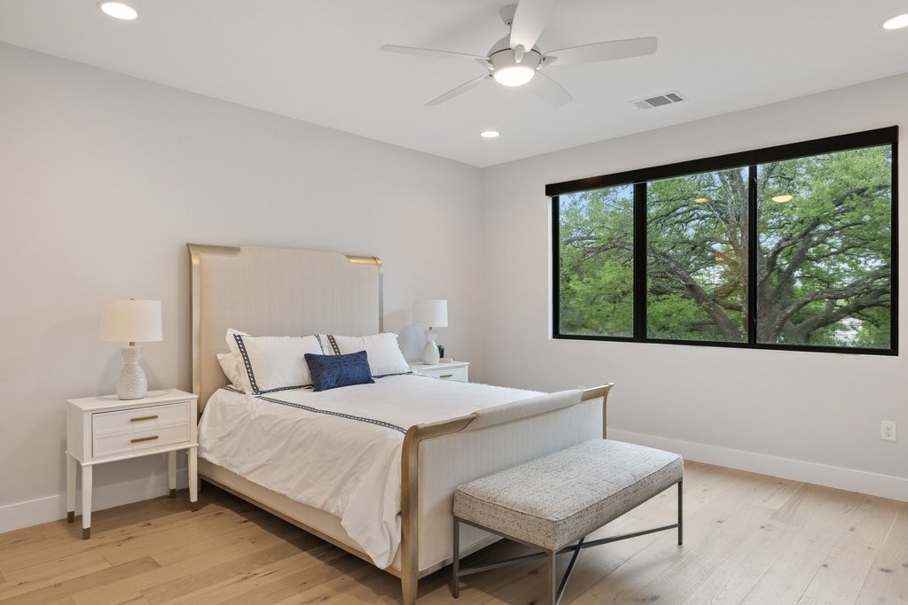 5405 Montview Street Austin, TX 78756 - Photo 23 of 40 Bedroom 3 is located on the second level with expansive windows overlooking mature trees.