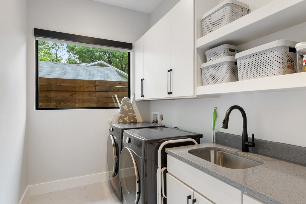5405 Montview Street Austin, TX 78756 - Photo 34 of 40 The main level laundry room is equipped with a sink and ample cabinet storage.