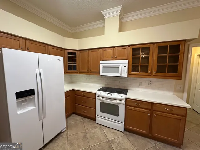 a kitchen with stainless steel appliances and white cabinets