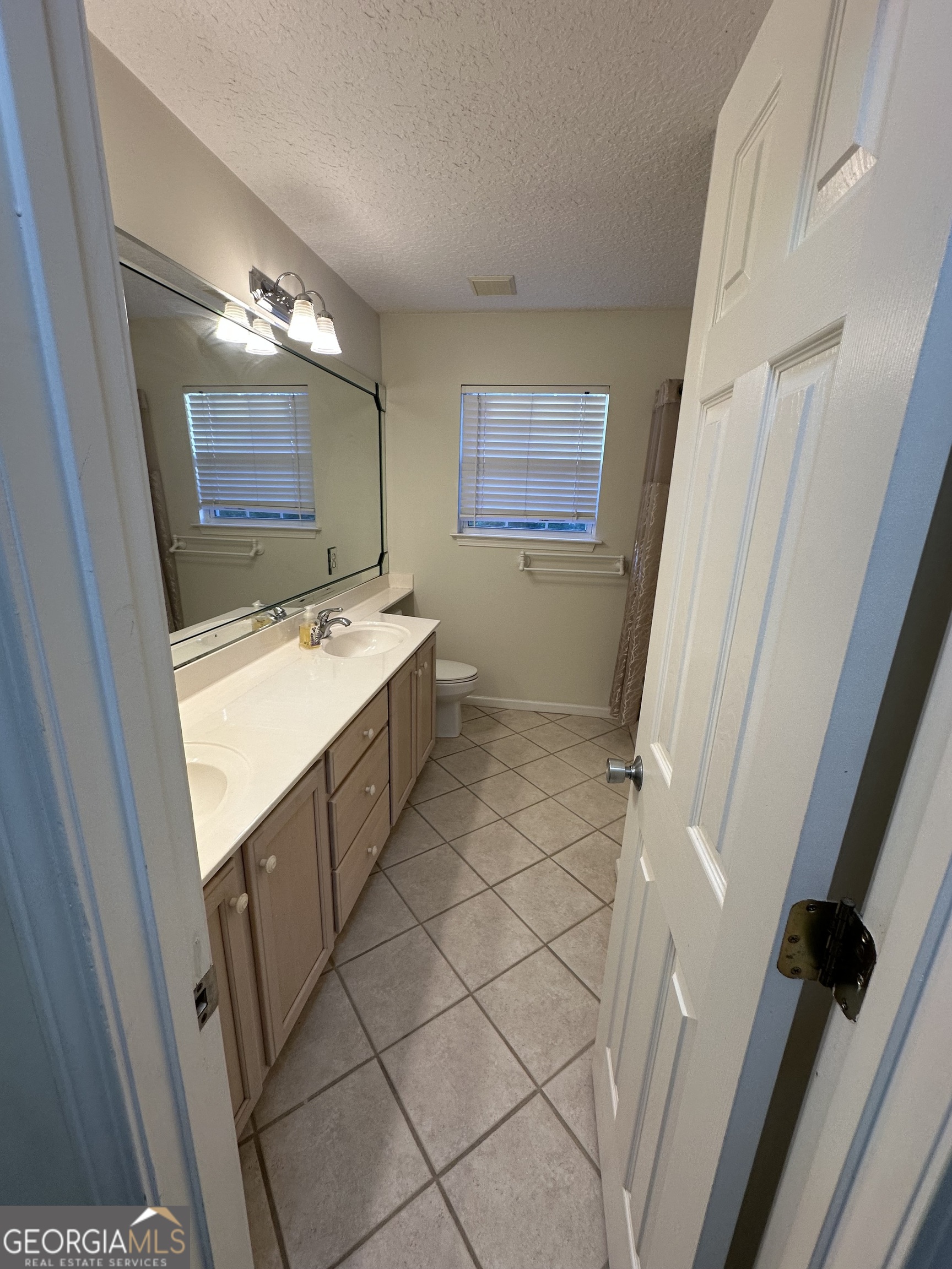 1024 Greenwillow Drive St. Marys, GA 31558 - Photo 29 of 35 a bathroom with a sink a toilet and a mirror
