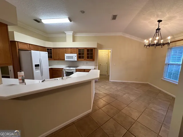 a kitchen with stainless steel appliances a sink stove and refrigerator