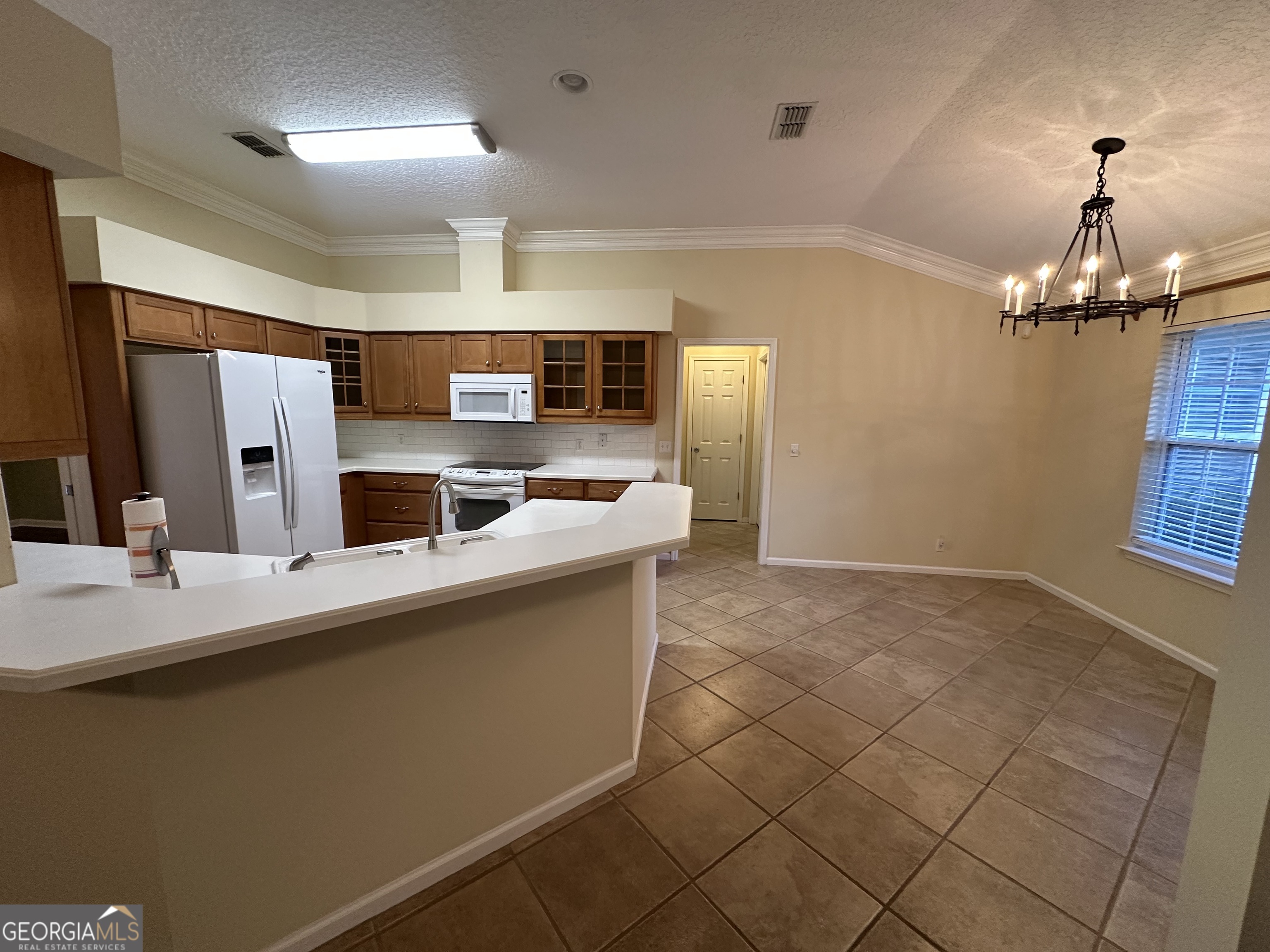 1024 Greenwillow Drive St. Marys, GA 31558 - Photo 9 of 35 a kitchen with stainless steel appliances a sink stove and refrigerator