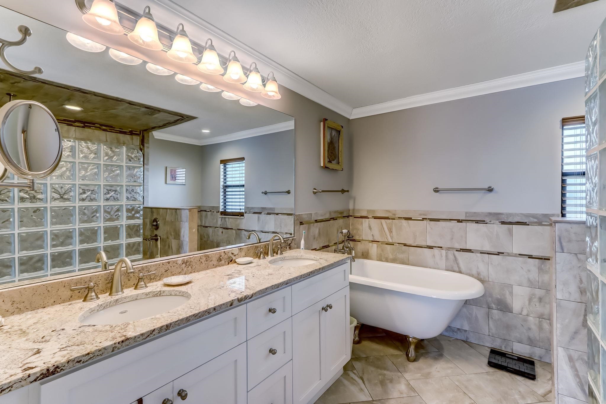 247 Treasure Beach Road St. Augustine, FL 32080 - Photo 21 of 28 a bathroom with a granite countertop sink and a mirror