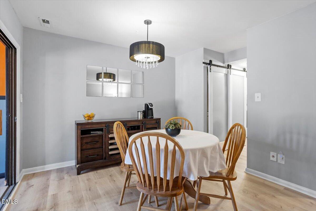 712 Godwin Court Raleigh, NC 27606 - Photo 14 of 27 a view of a dining room with furniture and wooden floor