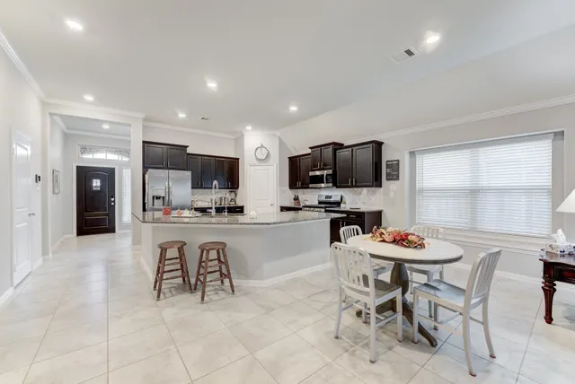 a kitchen with a table and chairs in it