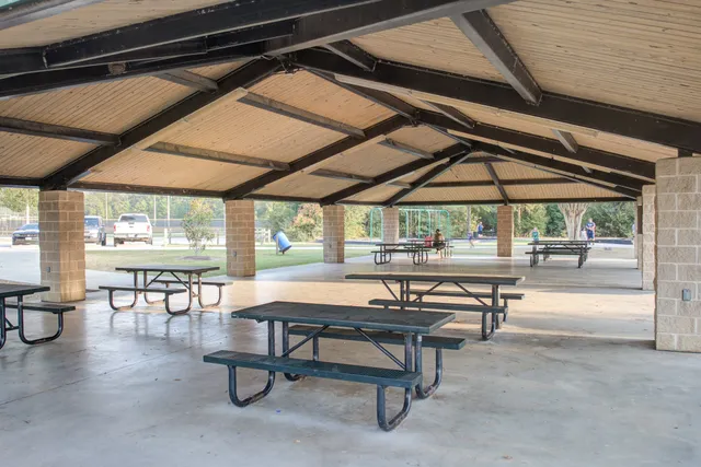 a view of a street with a bench and trees