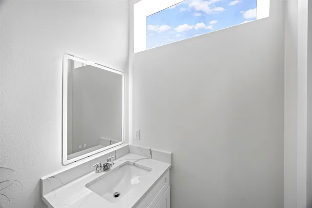 a bathroom with a sink and a mirror