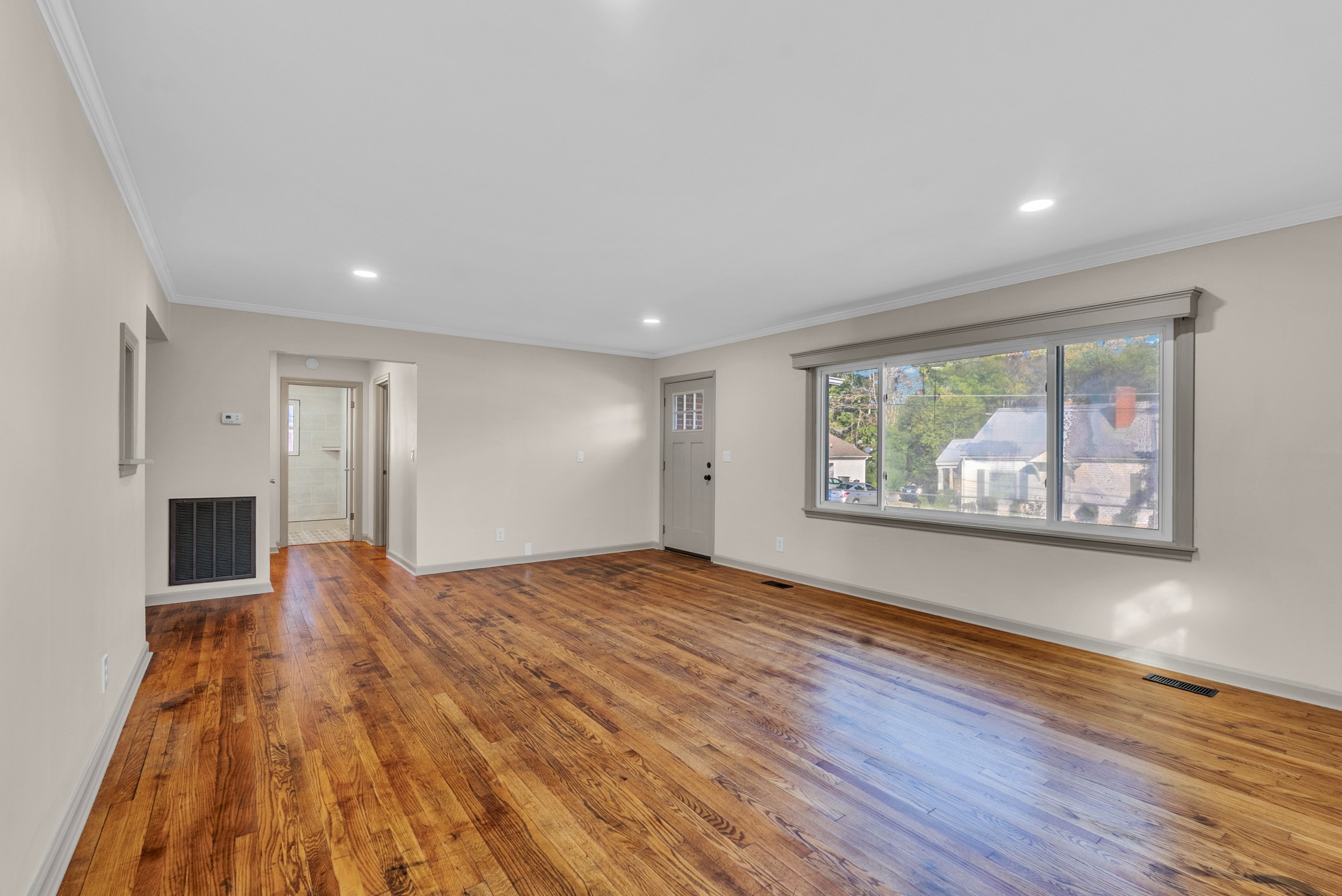 107 Oak Street Sparta, TN 38583 - Photo 3 of 26 a view of an empty room with wooden floor and a window