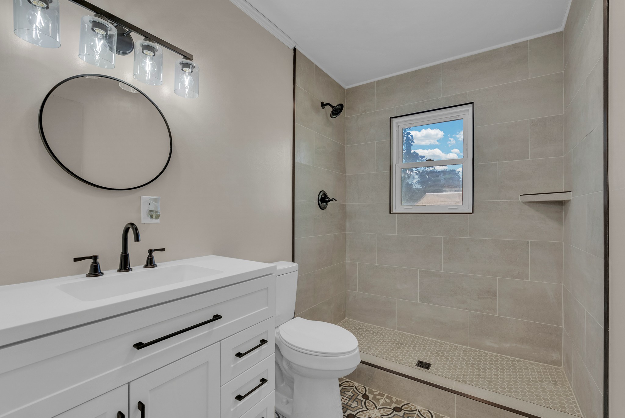 107 Oak Street Sparta, TN 38583 - Photo 4 of 26 a bathroom with a sink a toilet and a mirror