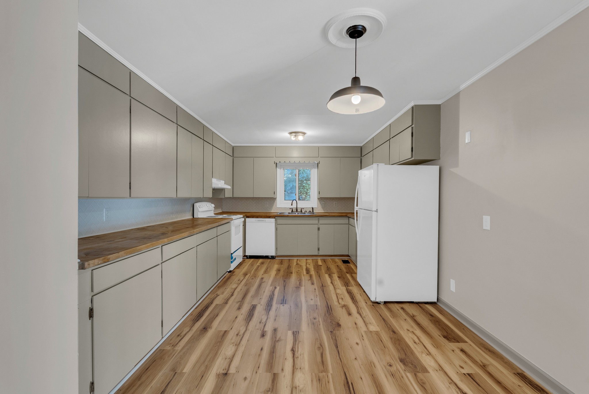 107 Oak Street Sparta, TN 38583 - Photo 5 of 26 a large kitchen with a lot of cabinets and wooden floor
