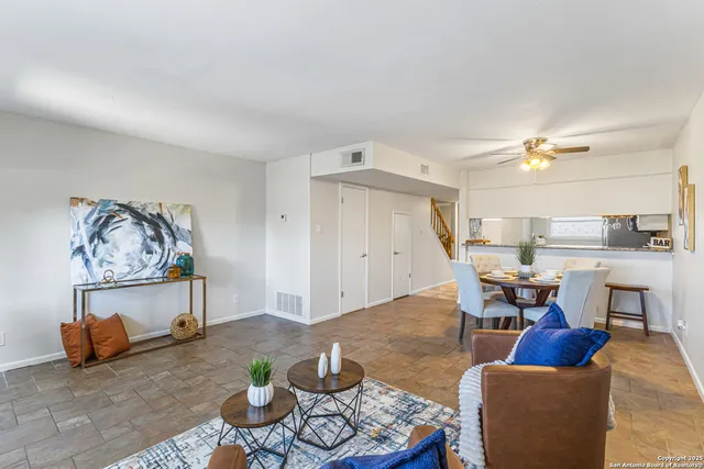 a living room with furniture and kitchen view