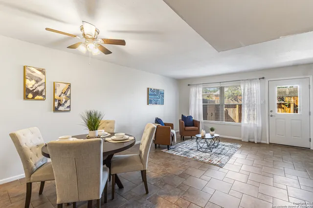 a dining room with furniture and window