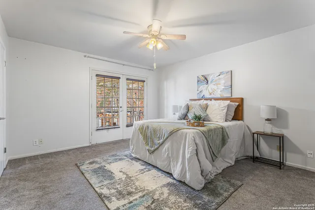 a spacious bedroom with a bed and a window