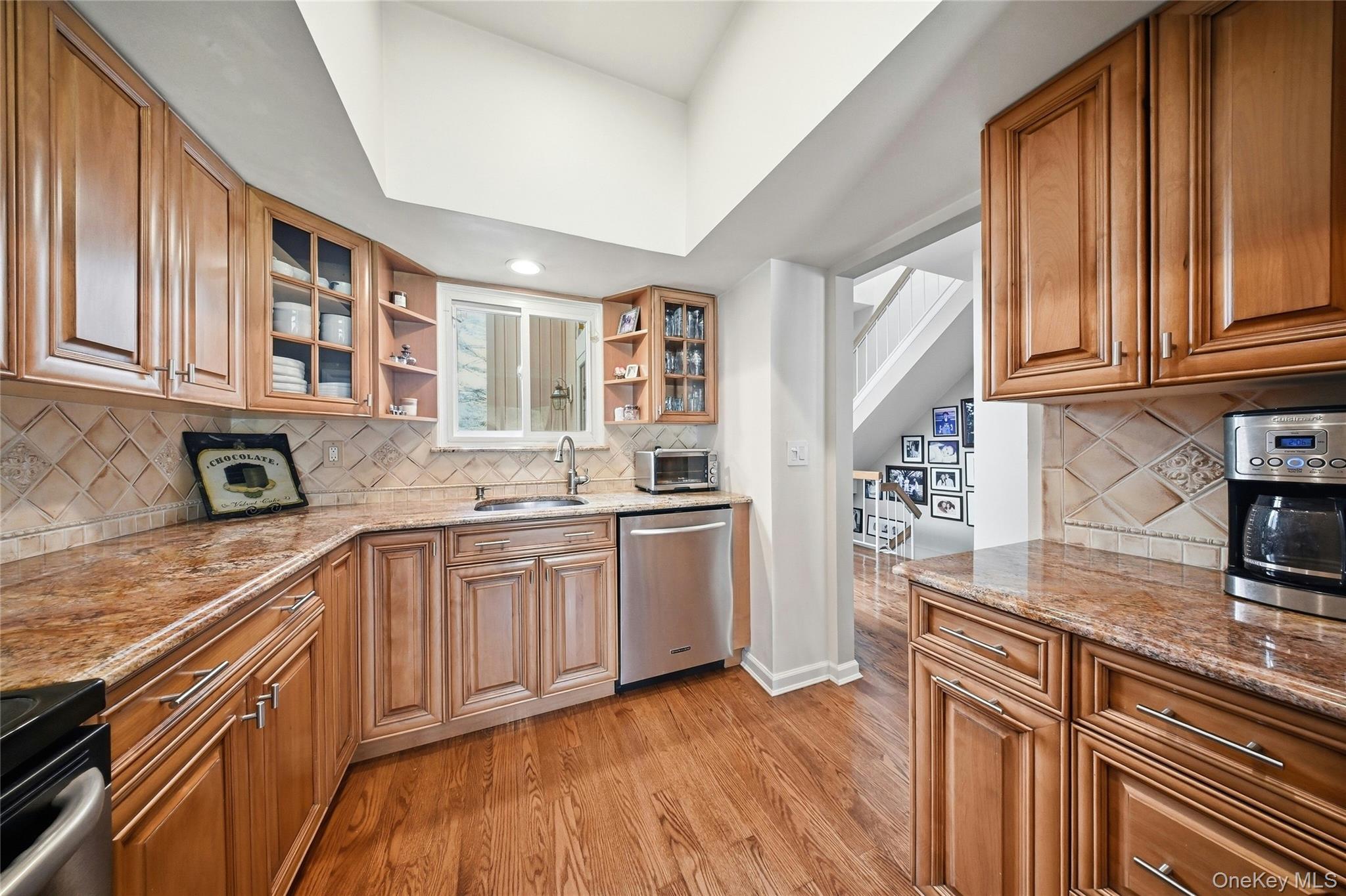 78 Hidden Ridge Drive Syosset, NY 11791 - Photo 6 of 21 a kitchen with granite countertop stainless steel appliances a sink window and cabinets