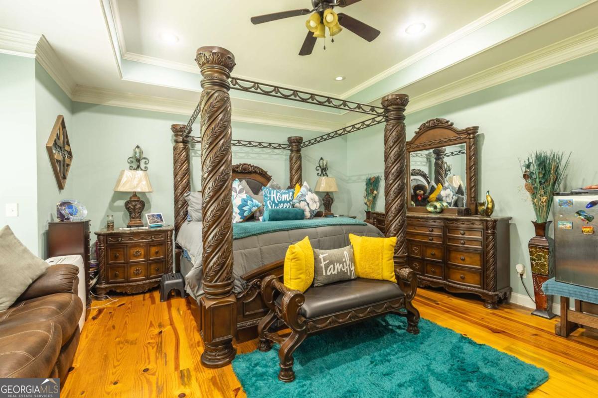 20 Ray Taylor Road Tifton, GA 31793 - Photo 16 of 46 a bedroom with furniture and a chandelier