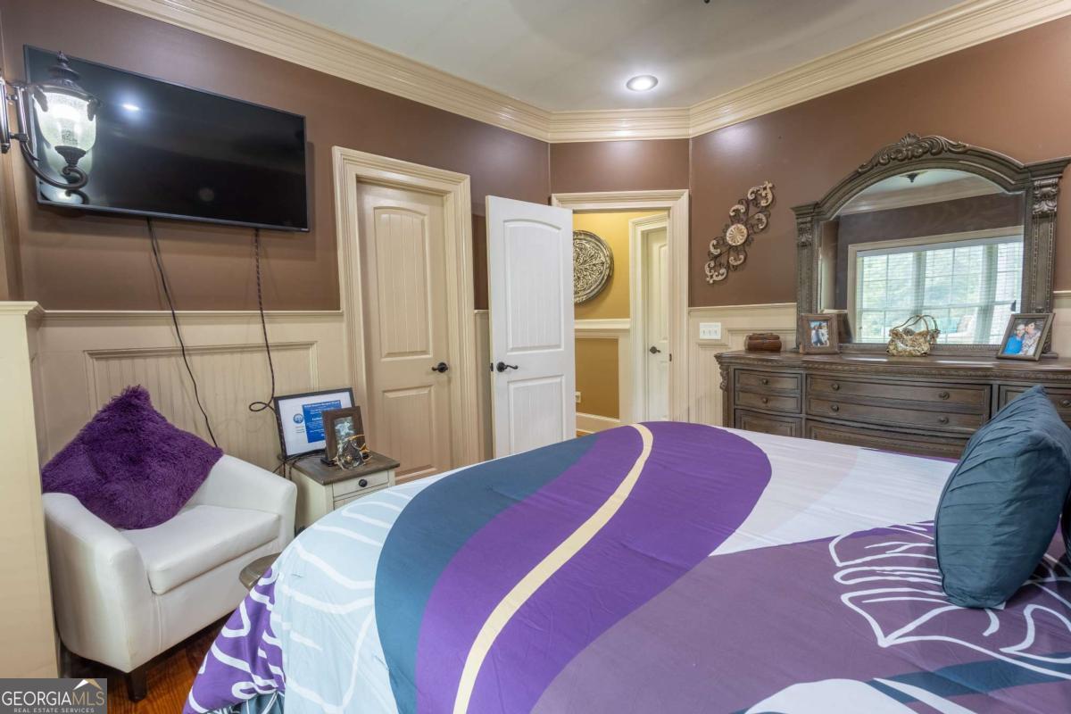 20 Ray Taylor Road Tifton, GA 31793 - Photo 22 of 46 a bedroom with a bed a couch and a flat screen tv