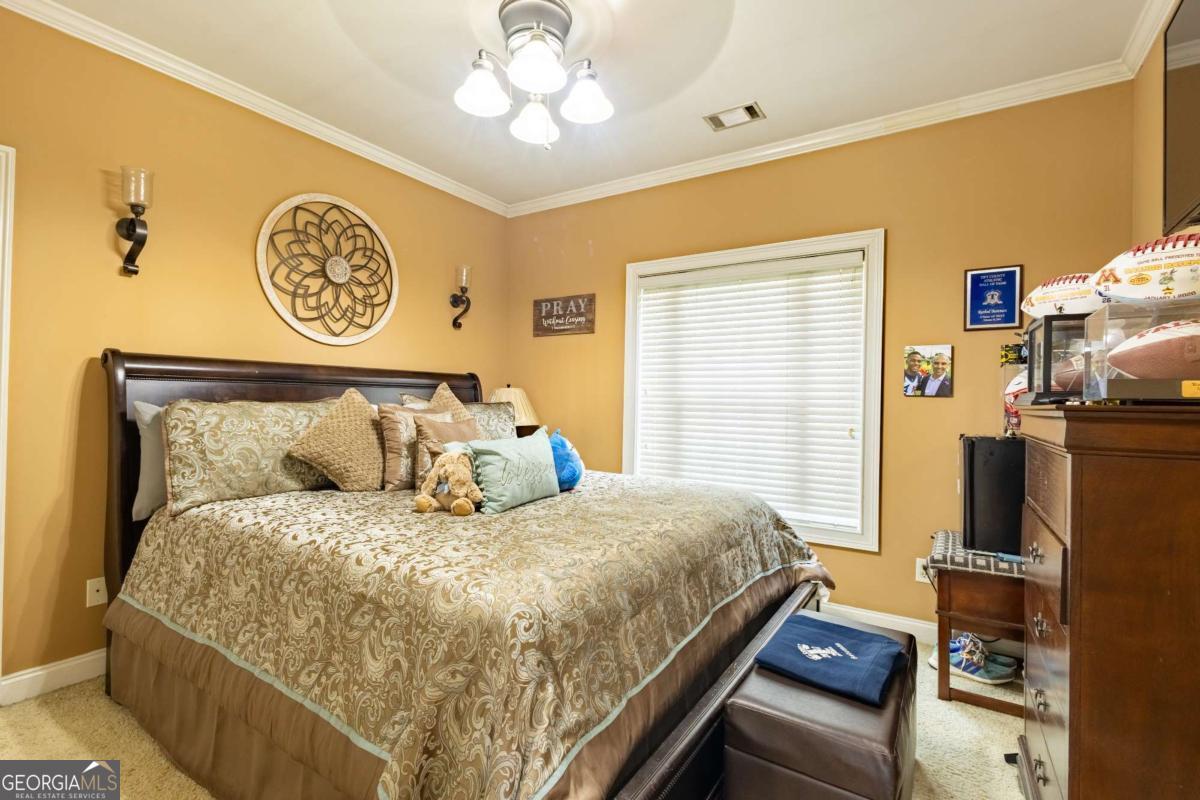 20 Ray Taylor Road Tifton, GA 31793 - Photo 30 of 46 a bedroom with a bed and a flat screen tv