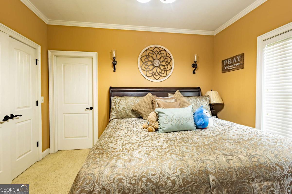 20 Ray Taylor Road Tifton, GA 31793 - Photo 31 of 46 a bedroom with a bed and painting on the wall