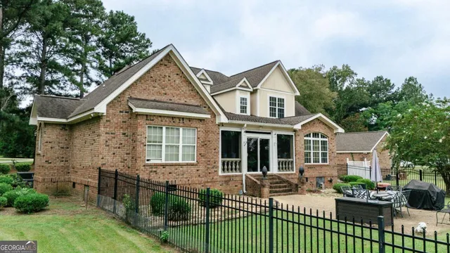 a view of a white house with a yard and plants