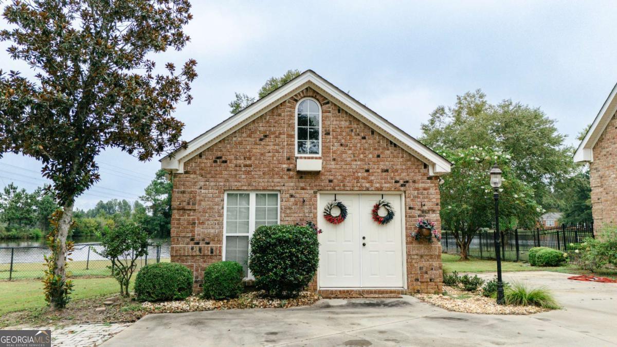 20 Ray Taylor Road Tifton, GA 31793 - Photo 42 of 46 a view of a white house with a yard and plants