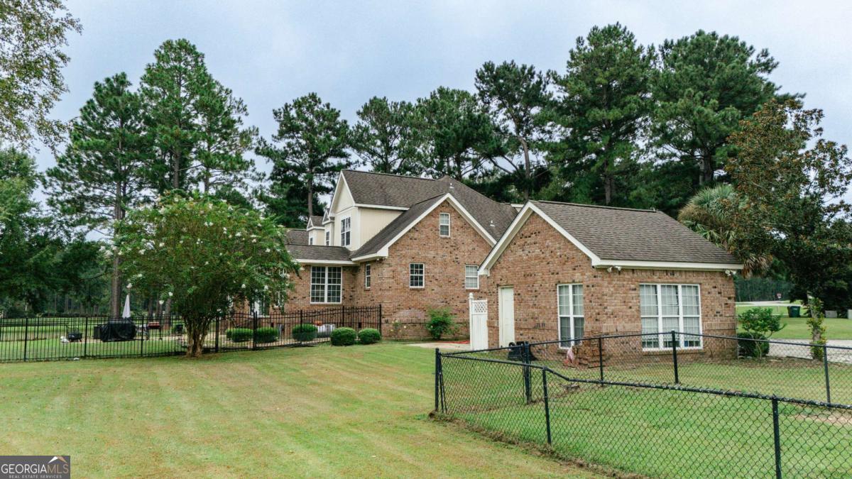 20 Ray Taylor Road Tifton, GA 31793 - Photo 43 of 46 a front view of a house with a garden and trees