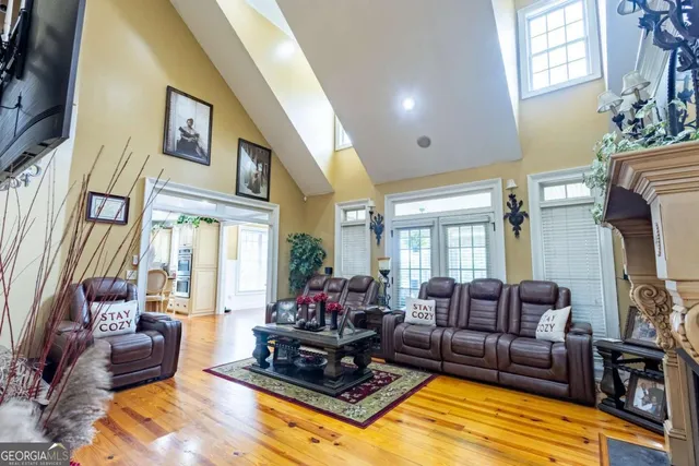 a living room with furniture fireplace and a large window