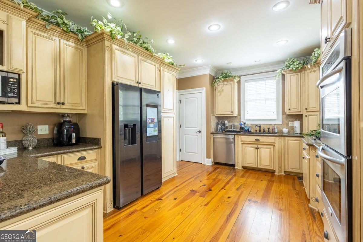 20 Ray Taylor Road Tifton, GA 31793 - Photo 9 of 46 a view of a kitchen with a sink a refrigerator and cabinets