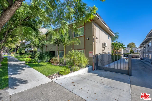 a view of a house with wooden fence