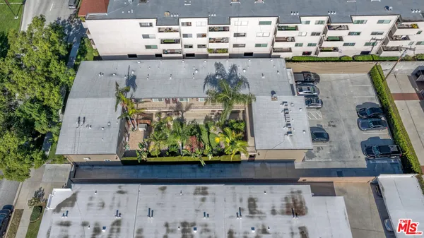 an aerial view of a house with a yard and sitting area