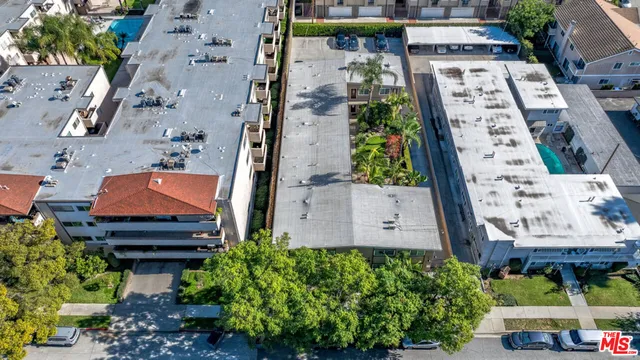 an aerial view of a house with garden space and street view