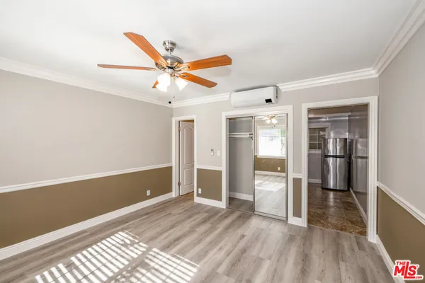 a view of a livingroom with wooden floor and a ceiling fan
