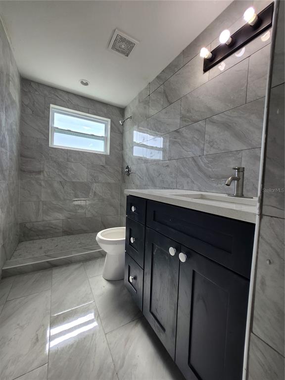 1302 West Shell Point Road Ruskin, FL 33570 - Photo 8 of 10 a bathroom with a sink a toilet and shower