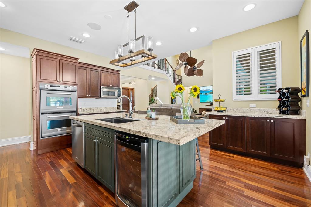 909 Turner Road Delray Beach, FL 33483 - Photo 12 of 50 a kitchen with stainless steel appliances granite countertop a sink a stove and a wooden floors