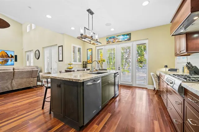 a kitchen with stainless steel appliances granite countertop a stove and cabinets