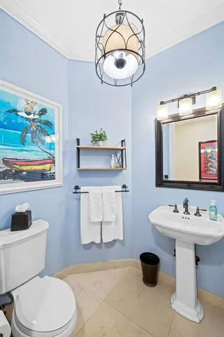 a bathroom with a sink a toilet and mirror