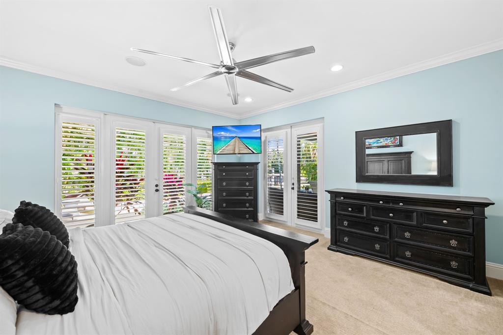 909 Turner Road Delray Beach, FL 33483 - Photo 18 of 50 a bedroom with a bed and a flat screen tv